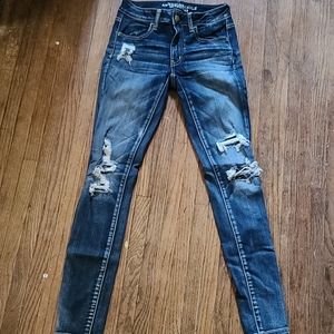 Dark blue distressed American Eagle jeggings.
